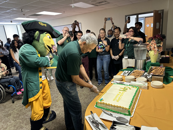 Dean Ajay Vinzé cuts the cake to wrap up "Spirit of Service" week. Photo provided